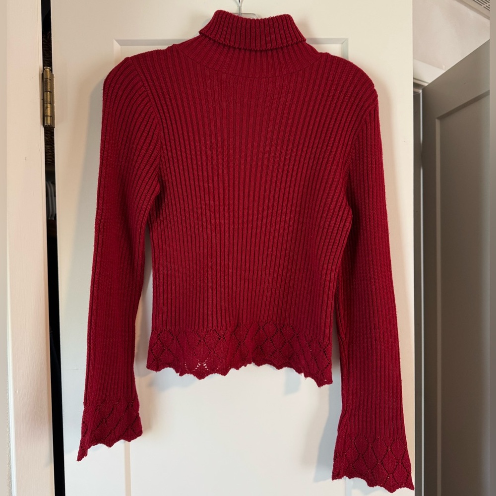 Red ribbed turtleneck with crochet detailing